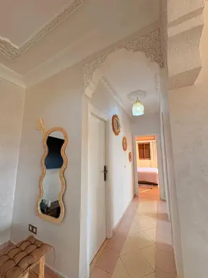 a hallway of a house with a mirror on the wall at A haven of light & sweetness in Marrakech