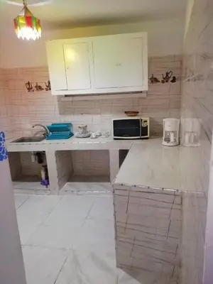 a kitchen with a counter top with a microwave at Dar Essalam in Marrakech