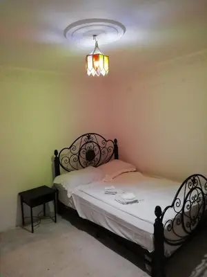 a bedroom with a bed and a chandelier at Dar Essalam in Marrakech