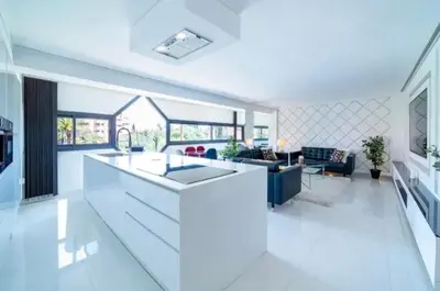 a kitchen and living room with a large counter top at Appartement luxe hivernage in Marrakech