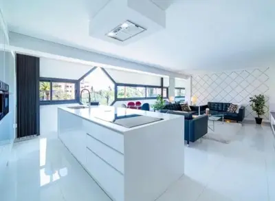 a kitchen and living room with a white counter top at Appartement luxe hivernage in Marrakech