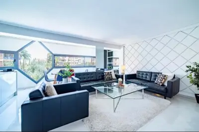 a living room with two couches and a table at Appartement luxe hivernage in Marrakech