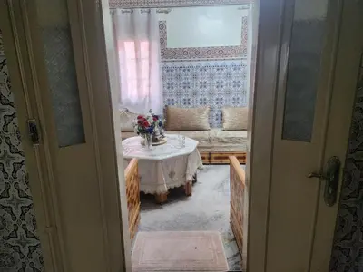 a living room with a table and a couch at Dar Damana in Marrakech