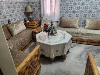 a living room with a table with flowers on it at Dar Damana in Marrakech
