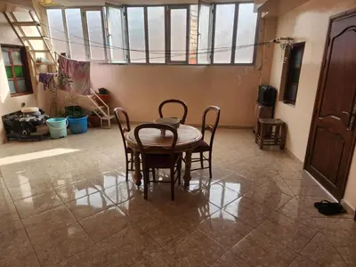 a dining room with a table and chairs in a room at Dar Damana in Marrakech