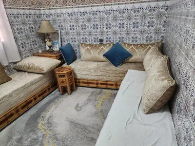 a room with a couch and pillows on a wall at Dar Damana in Marrakech