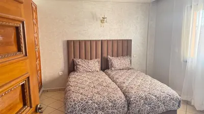 a bed with two pillows in a bedroom at 3 bedrooms 2 balconies kitchen, salon 2 bathrooms in Marrakech
