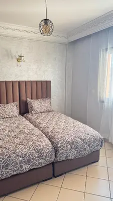 a bedroom with a bed in a room with at 3 bedrooms 2 balconies kitchen, salon 2 bathrooms in Marrakech