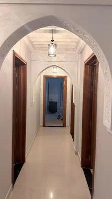 an archway leading to a hallway in a house at 3 bedrooms 2 balconies kitchen, salon 2 bathrooms in Marrakech