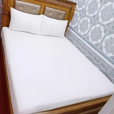 a bed with white sheets and pillows in a room at Dar Saada Bab Doukkala in Marrakech