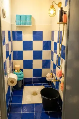 a blue and white bathroom with a toilet and a tub at Dar Saada Bab Doukkala in Marrakech