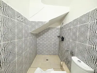a bathroom with a white toilet and a sink at Havre de calme - Cour & 2 chambres in Marrakech