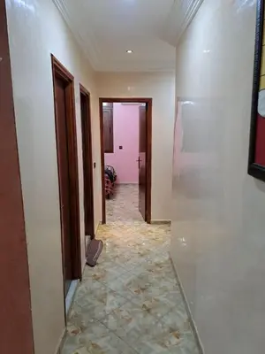a hallway of a room with white walls and a tile floor at Happy space in Marrakech