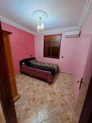 a bedroom with a bed in a pink wall at Happy space in Marrakech