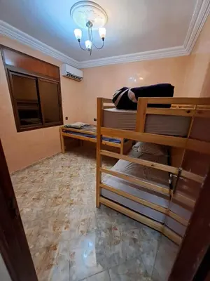 a room with two bunk beds and a chandelier at Happy space in Marrakech