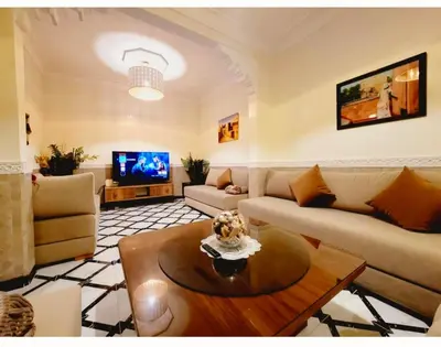 a living room with a couch and a coffee table at Riad Privatif 250m2 près Médina-palais Royal in Marrakech