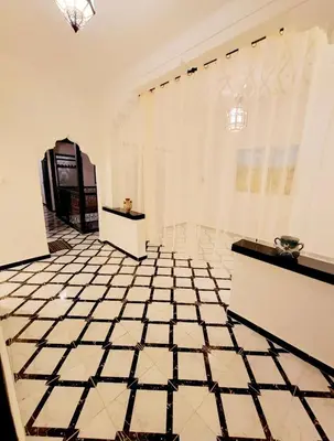 a white room with a black and white tiled floor at Riad Privatif 250m2 près Médina-palais Royal in Marrakech