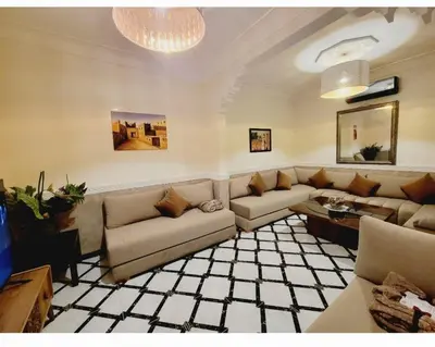 a living room with couches and a chandelier at Riad Privatif 250m2 près Médina-palais Royal in Marrakech