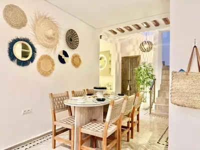 a dining room with a table and chairs at Riad des bibouches pool breakfast private in Marrakech
