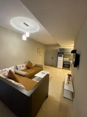 a living room with a couch and a table at Cosy 1 Bedroom flat marrakech city center in Marrakech