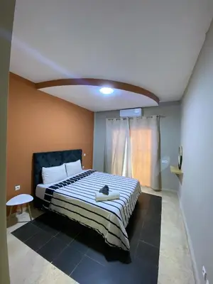 a bedroom with a bed with a cat laying on it at Cosy 1 Bedroom flat marrakech city center in Marrakech