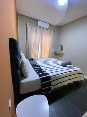a bedroom with a bed and a window at Cosy 1 Bedroom flat marrakech city center in Marrakech