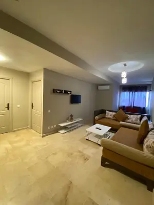 a living room with a couch and a table at Cosy 1 Bedroom flat marrakech city center in Marrakech