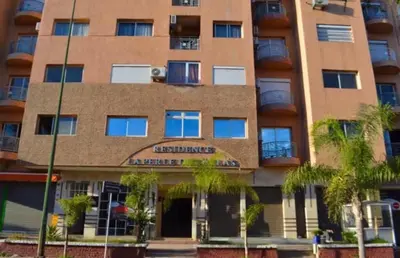an apartment building with a sign that reads anaheim apartment at Cosy 1 Bedroom flat marrakech city center in Marrakech