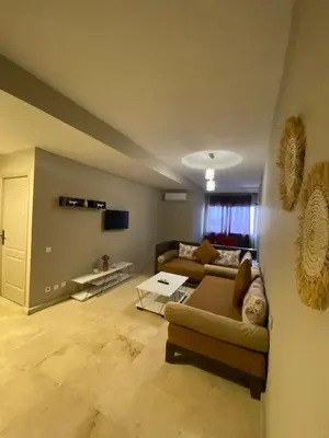 a living room with a couch and a table at Cosy 1 Bedroom flat marrakech city center in Marrakech