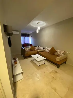 a living room with two couches and a tv at Cosy 1 Bedroom flat marrakech city center in Marrakech