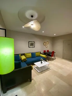 a living room with a blue couch and a table at Red city charm - city center apartment in Marrakech