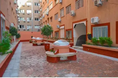 a courtyard of a building with benches and buildings at Nice apartment in Marrakech center in Marrakech
