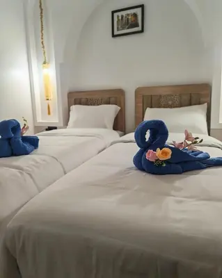 two beds with stuffed animals on top of them at Riad Dar Barka Privatisé 3 chambres in Marrakech