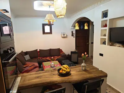 a living room with a couch and a table at Riad Dar Barka Privatisé 3 chambres in Marrakech