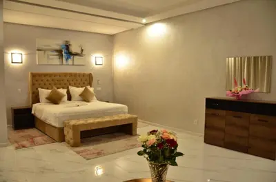 a bedroom with a bed and a vase of flowers at Villa à la palmeraie in Marrakech