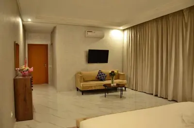 a living room with a couch and a tv at Villa à la palmeraie in Marrakech
