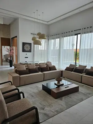 a living room with couches and a coffee table at Villa Nobu - Architect-designed villa with pool in Douar Bellouk