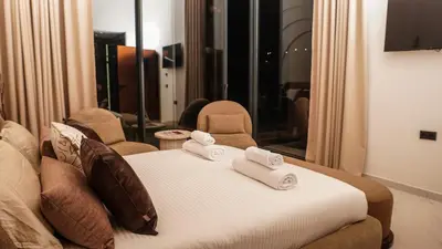 a hotel room with a bed with towels on it at Villa Nobu - Architect-designed villa with pool in Douar Bellouk