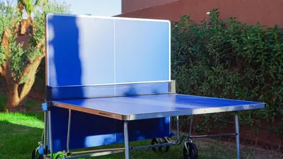 a blue ping pong table with a refrigerator on it at Villa Nobu - Architect-designed villa with pool in Douar Bellouk