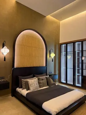 a bedroom with a large bed with an arch above it at Villa Nobu - Architect-designed villa with pool in Douar Bellouk