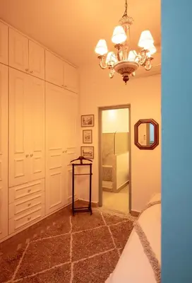 a bedroom with a chandelier and a bed and a mirror at Riad Cosy in Marrakech