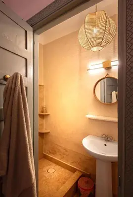 a bathroom with a sink and a mirror at Riad Cosy in Marrakech