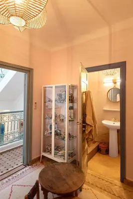 a bathroom with a sink and a glass cabinet at Riad Cosy in Marrakech