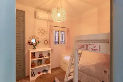 a small bedroom with a bunk bed and a bunk bedwered at Riad Cosy in Marrakech