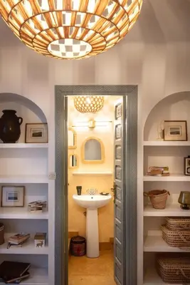 a bathroom with a sink and a chandelier at Riad Cosy in Marrakech