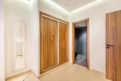 a bathroom with a wooden closet and a door at Sweet Clarity Swimming pool and Parking in Marrakech