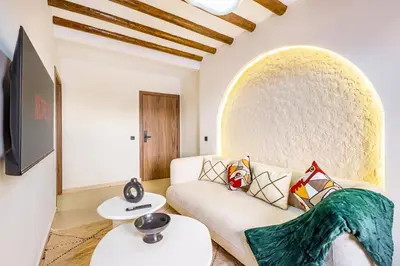 a living room with a couch and a tv at Sweet Clarity Swimming pool and Parking in Marrakech