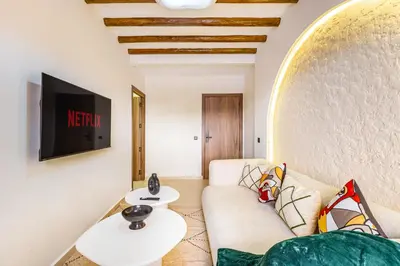 a living room with a couch and a tv at Sweet Clarity Swimming pool and Parking in Marrakech