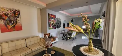 a living room with a couch and a table at Villa Maison Dar Sukar in El Caïd Omar