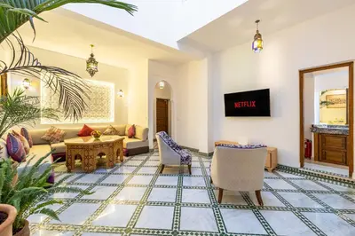 a living room with a couch and a table at Riad Mimouna - Rooftop view & Breakfast included - 4 Rooms - Fully private in Marrakech